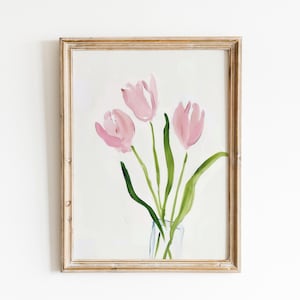 May include: A framed painting of three pink tulips in a clear glass vase. The tulips are painted in a loose, impressionistic style with soft, blended colors.