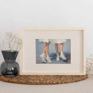 May include: A framed painting depicting two pairs of legs wearing white trainers. The legs are painted in a realistic style with a soft, muted colour palette. The background is a light blue.