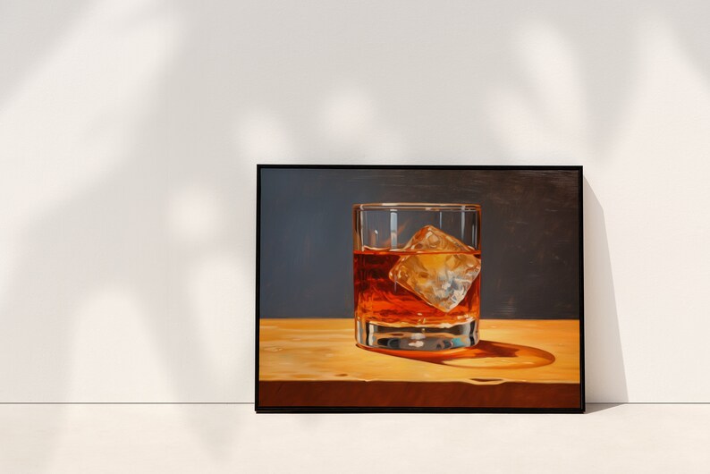 May include: A framed painting of a glass of amber liquid with a large ice cube, sitting on a wooden surface.