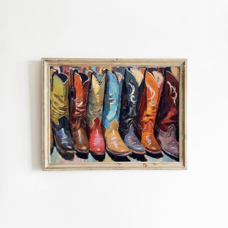 May include: A framed painting depicting a row of cowboy boots in various colors including yellow, red, blue, black, and brown. The artwork features visible brushstrokes and highlights the distinct pointed toes and tall shafts of the footwear.