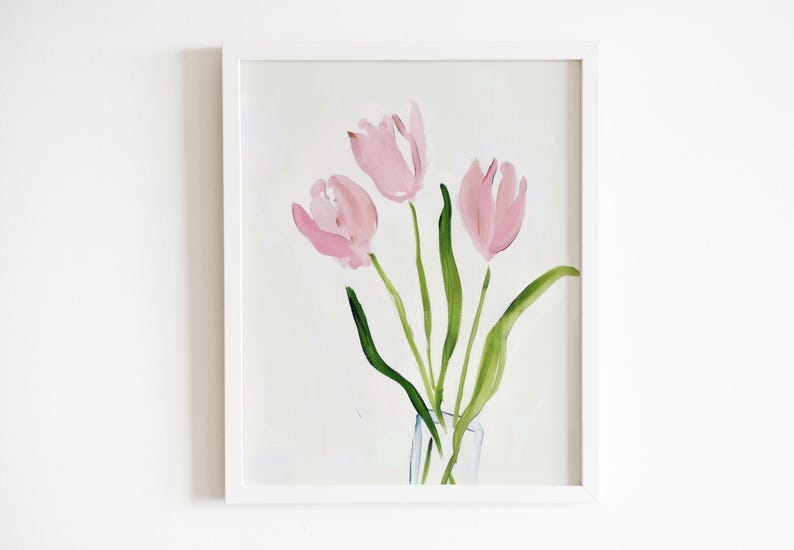 May include: A framed painting of three pink tulips in a clear glass vase. The tulips are painted in a loose, abstract style with soft edges. The background is a light, neutral color.