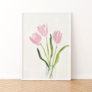 May include: A watercolor painting of three pink tulips in a clear glass vase. The tulips are arranged in a bouquet with green stems and leaves.