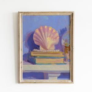 May include: Oil painting of a seashell resting on two books, with a string of pearls. The artwork is framed in a gold-colored frame. The background is a soft blue, with hints of other colors.