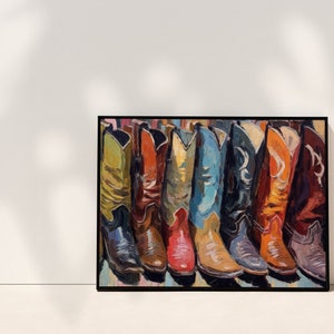 May include: A framed rectangular wall art print featuring a painted row of seven cowboy boots in various colors including yellow, red, blue, black, and orange. The painting uses visible brushstrokes to depict the leather texture and stitching.