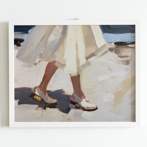 May include: An oil painting framed in white depicts a person walking, with focus on the legs and feet. The person wears a white dress and white shoes with gold accents. The artwork uses a palette of whites, creams, and blues.