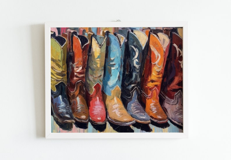 May include: An oil painting in a white frame depicting a row of colorful cowboy boots. The boots are rendered in vibrant shades of yellow, orange, red, blue, black, and brown, featuring visible brushstrokes and detailed stitching patterns.