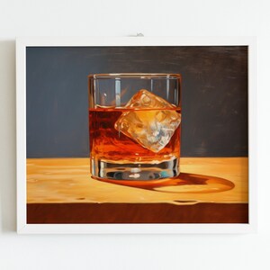 May include: A glass of amber-colored liquid with a large ice cube, sitting on a wooden surface. The glass is clear and has a rounded bottom.