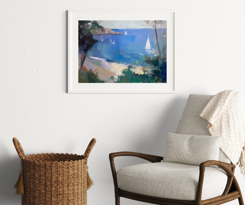May include: A framed painting of a seascape with white sailboats on a blue body of water. The painting is framed in white and is hanging on a white wall.