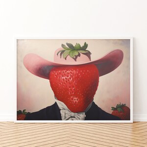 Peut inclure: Une impression d'art encadr&eacute;e repr&eacute;sentant une fraise rouge vif avec un sommet feuillu vert portant un chapeau rose &agrave; larges bords. La fraise est v&ecirc;tue d'une veste de costume noire avec une chemise blanche &agrave; col et un n&oelig;ud papillon blanc, avec deux fraises.