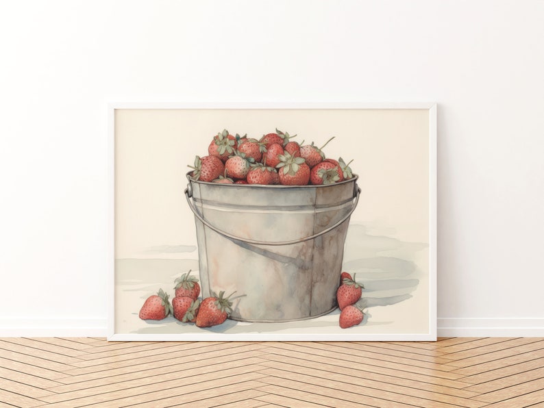 May include: A watercolor painting of a metal bucket filled with red strawberries. The bucket is sitting on a white surface with a few strawberries scattered around it.