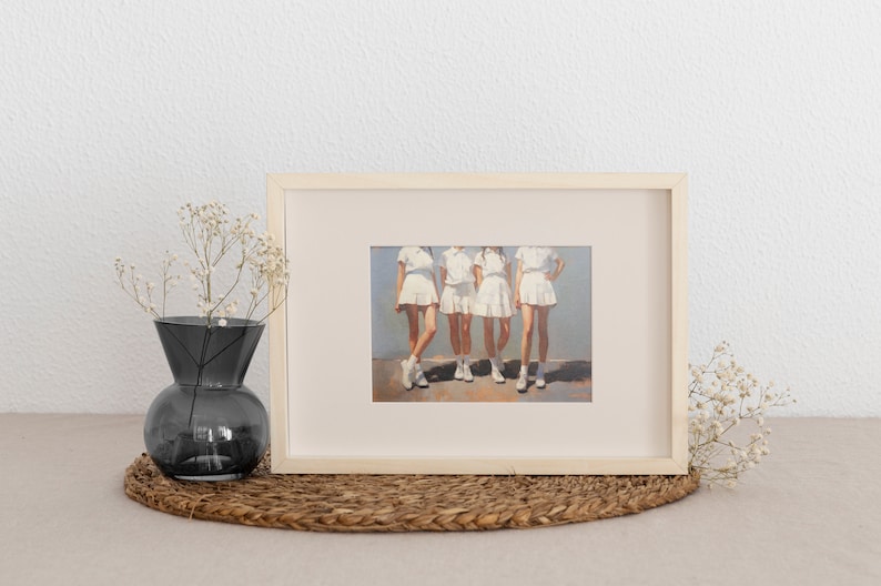 May include: Framed painting of four people wearing white dresses and standing in a row. The background is a light blue color.