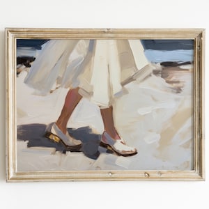 May include: Oil painting print in a gold frame. The artwork depicts a person walking, with a white dress and white shoes. The painting uses a palette of white, beige, and blue tones, creating a soft, impressionistic style.