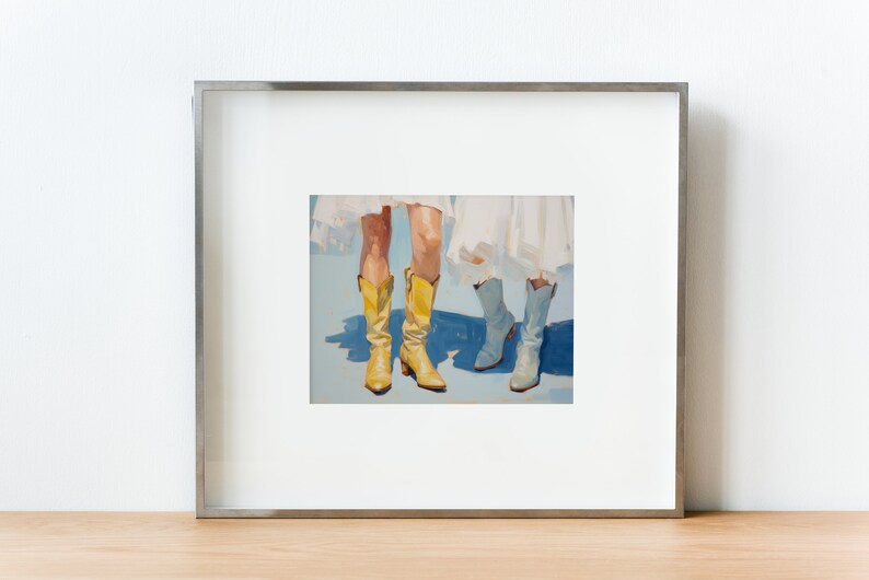May include: A framed painting of two pairs of legs wearing boots. One pair is wearing yellow cowboy boots and the other pair is wearing light blue boots. The background is a light blue color.
