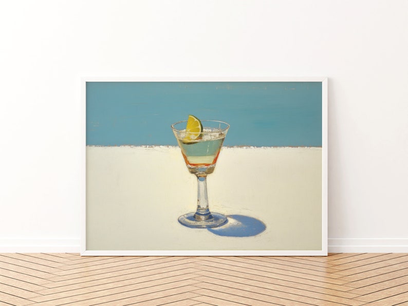 May include: A painting of a martini glass with a lime wedge on a white surface against a blue background.
