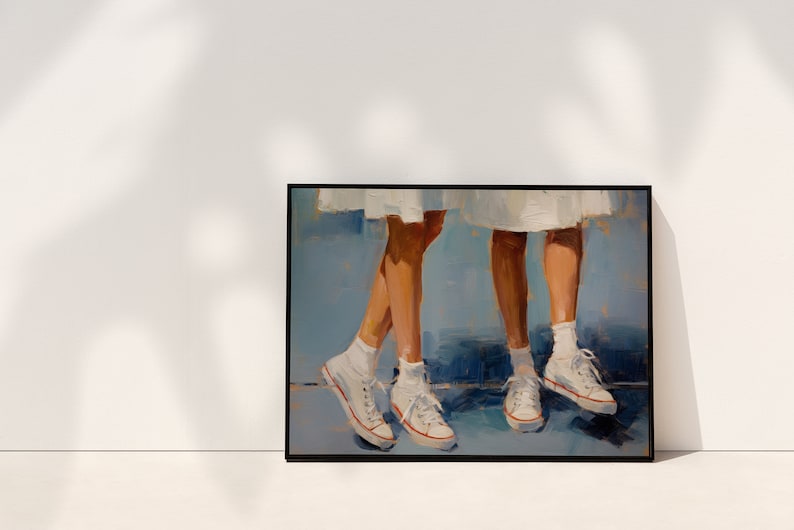 May include: A painting depicting two pairs of legs wearing white trainers with red accents. The legs are wearing white socks and are standing on a blue surface. The painting is framed in black.