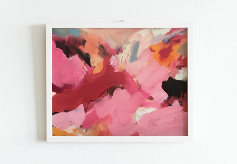 May include: Abstract painting in a white frame. The artwork features a vibrant mix of pink, red, orange, and black brushstrokes. The composition is a dynamic blend of colors and textures, creating a modern aesthetic.