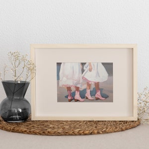 May include: A framed painting of two girls wearing white dresses and pink boots. The girls are standing side by side and their legs are crossed at the ankles.