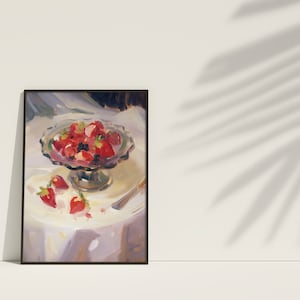May include: A painting of a bowl of red strawberries on a white tablecloth. The bowl is on a pedestal and there are a few strawberries scattered around the bowl.
