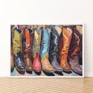 May include: A framed painting depicting a row of colorful cowboy boots in various shades including yellow, orange, red, blue, black, and brown. The artwork features visible brushstrokes and a textured application of paint, showcasing the boots side by side.