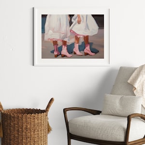 May include: Painting of two people wearing white dresses and pink cowboy boots. The painting is framed in a white frame.