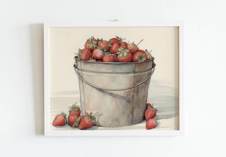 May include: A watercolor painting of a metal bucket filled with ripe red strawberries. The bucket is sitting on a white surface with a few strawberries scattered around it.