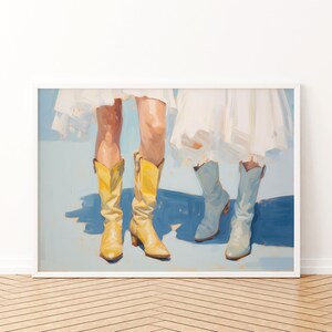 May include: A painting of two pairs of legs wearing boots. One pair is wearing yellow cowboy boots and the other pair is wearing light blue cowboy boots. The legs are wearing white dresses.
