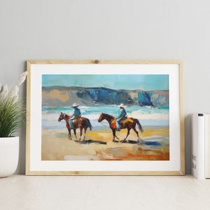 Peut inclure: Une peinture repr&eacute;sentant deux personnes &agrave; cheval sur une plage. Les chevaux sont bruns et les cavaliers portent un jean bleu et un chapeau blanc. La plage est sablonneuse et l'oc&eacute;an est bleu. La peinture est encadr&eacute;e de bois.