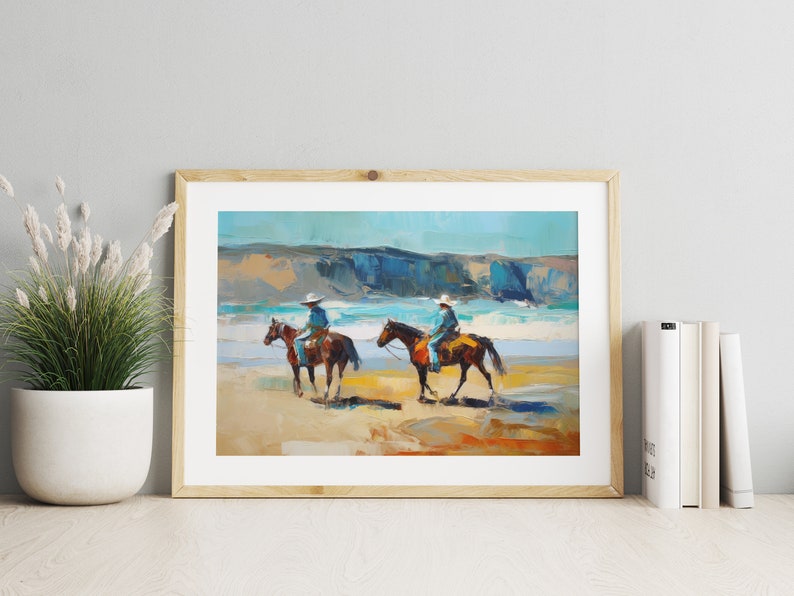Peut inclure: Une peinture repr&eacute;sentant deux personnes &agrave; cheval sur une plage. Les chevaux sont bruns et les cavaliers portent un jean bleu et un chapeau blanc. La plage est sablonneuse et l'oc&eacute;an est bleu. La peinture est encadr&eacute;e de bois.