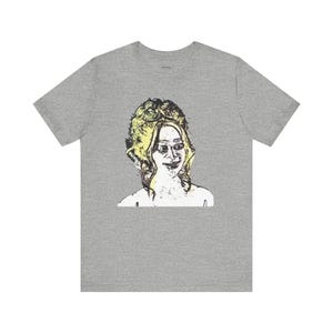 May include: A gray t-shirt with a black and white line drawing of a woman with blonde hair. The woman is smiling and looking to the right. The drawing is in a vintage style.
