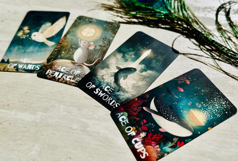 May include: Four rectangular tarot cards labeled Ace of Wands, Ace of Pentacles, Ace of Swords, and Ace of Cups. The cards feature illustrations of an owl, a mouse, a fish, and a whale in dark, atmospheric, and colorful underwater or night settings.