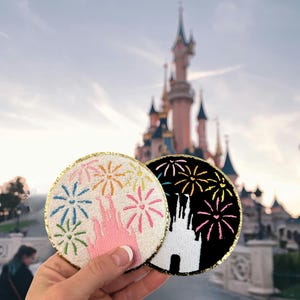 May include: A white ceramic mug with a black handle and the text "But First, Coffee" in a black, handwritten-style font. The mug is on a white surface.