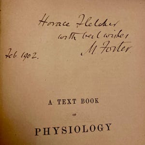 May include: A vintage book page with handwritten inscriptions and the title "A Text Book of Physiology." The signatures "Horace Fletcher" and "M. Foster" are visible, along with the date "Feb. 1902."