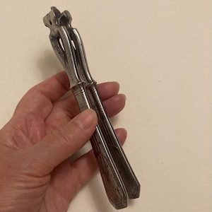 Aesthetic antique metal nut cracker. Lovely design on all sides.