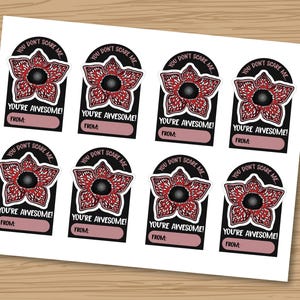 May include: Sheet of eight stickers with a Demogorgon flower design from the show Stranger Things. Each sticker has the text "You don't scare me" and "You're awesome!" with a space to write "From:"