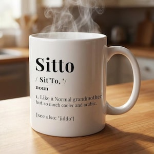 May include: White ceramic mug with the word "Sitto" in large black letters. The mug also includes a definition, "Like a Normal grandmother but so much cooler and arabic."