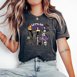 Let’s Go Ghouls retro  Scantily Clad Witches Unisex Tee - Bold Halloween Graphic Shirt - Fun & Spooky Jersey Short Sleeve T-Shirt