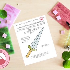 May include: A printable stained glass pattern for a fantasy fey dagger. The pattern is labeled "Novice" and includes 6 pieces, measuring approximately 3.5 inches tall and 8.5 inches wide.