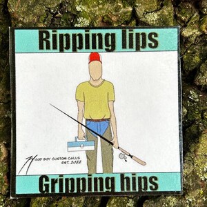 May include: A sticker with a cartoon illustration of a person fishing. The person is wearing a red hat, yellow shirt, blue jeans, and waders. The sticker has the text "Ripping lips" and "Gripping hips" and the logo "Wood Boy Custom Calls Est. 2022".