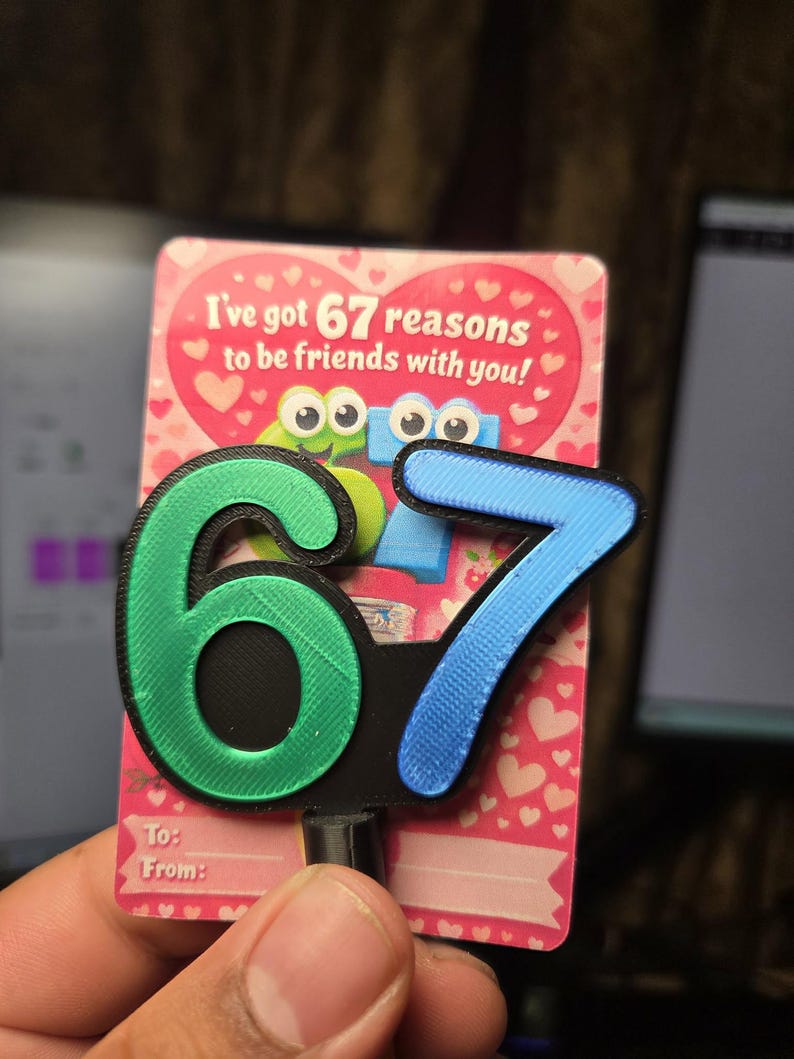 May include: A friendship card with the text "I've got 67 reasons to be friends with you!" and a 3D-printed "67" in green and blue. The card has a pink background with white hearts and space to write "To:" and "From:"