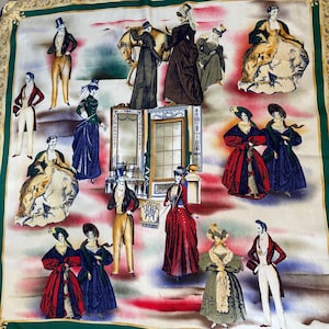 May include: A silk scarf with a green border featuring illustrations of people in 18th-century attire. The illustrations depict men in tailcoats and women in elaborate gowns, with a backdrop of architectural elements and a horse.