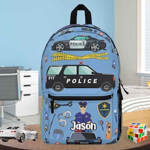 May include: A light blue backpack featuring police car graphics, including a black SUV and a sports car, along with police-themed icons. The name "Jason" is printed on the front. Includes a black top handle and a front pocket.