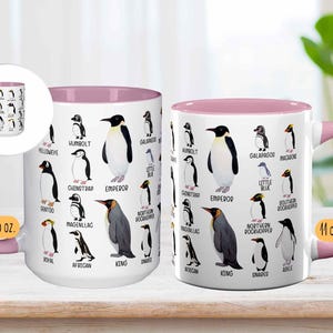 May include: White ceramic mug with a pink interior and handle, featuring illustrations of various penguin species with their names. The mug is labeled "15 oz." and "11 oz."