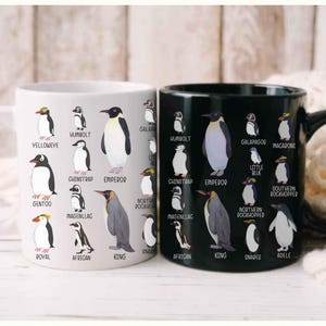 May include: Two ceramic mugs, one white and one black, each adorned with illustrations of various penguin species. The white mug features penguins like Gentoo and Emperor, while the black mug showcases penguins such as Humboldt and Macaroni.