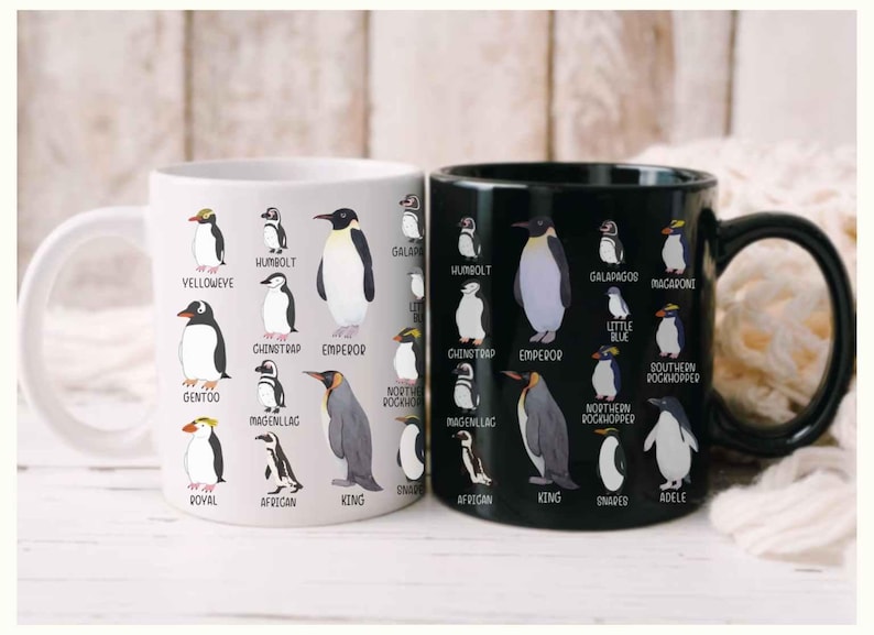 May include: Two ceramic mugs, one white and one black, each adorned with illustrations of various penguin species. The white mug features penguins like Gentoo and Emperor, while the black mug showcases penguins such as Humboldt and Macaroni.