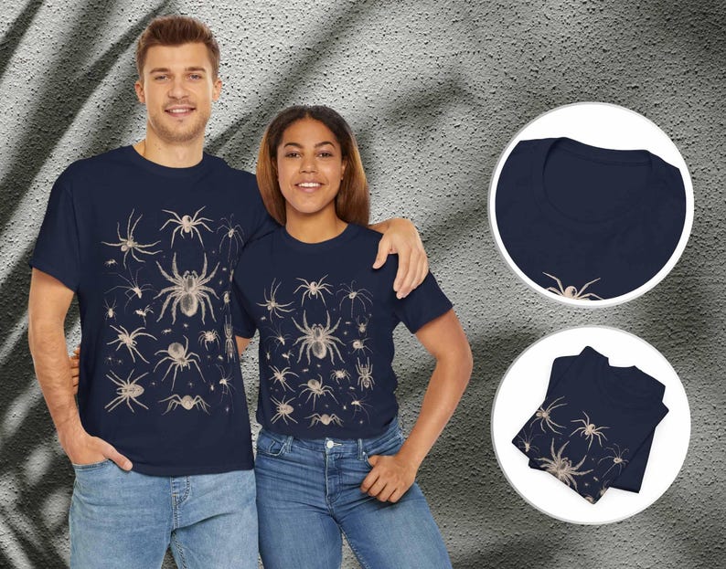 May include: A navy blue short-sleeved t-shirt featuring a repeating pattern of various spider illustrations in a light beige colour. The design is displayed on the front of the shirt, with additional circular insets showing the neckline and folded fabric.