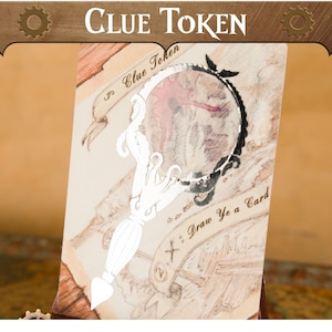 以下が含まれることがあります： 拡大鏡のデザインが施されたClue Tokenカード。カードは、上部に「Clue Token」、下部に「Draw Ye a Card」というテキストが入った地図のような背景が特徴です。拡大鏡は白黒です。
