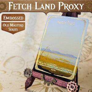 May include: A gold-trimmed proxy card for the Magic: The Gathering card "Marsh Flats". The card features a landscape scene with a body of water and a sky with clouds. The card text reads "Land - Top: Pay the sacrifice this land. Search your library for a Plains or Swamp, put it into the battlefield, then shuffle."