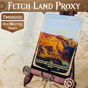 May include: A gold foil proxy card for the Magic: The Gathering card Windswept Heath. The card features a landscape image of a canyon with a blue sky and clouds. The card text reads "Land. Tap, Pay life, sacrifice this land: Search your library for a Forest or Plains, put it into the battlefield, then shuffle."