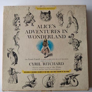 May include: Vintage vinyl record album cover for "Alice's Adventures in Wonderland." The cover features illustrations of characters from the story, including Alice, the Cheshire Cat, and the Mad Hatter. The album includes a facsimile volume of the rare 1865 first edition.