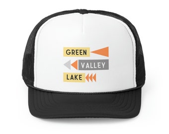May include: A black and white trucker hat with a white front panel featuring the text "GREEN VALLEY LAKE" in a retro style with orange and gray arrows.